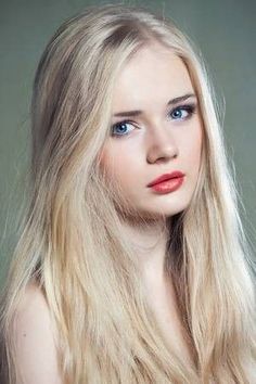 Young woman with long blonde hair and blue eyes looking at the camera