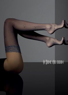 Woman's legs in patterned stockings with lace trim, studio shot