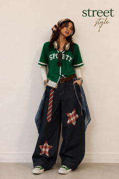 Woman in a green baseball jersey and baggy jeans with a bandana and headphones