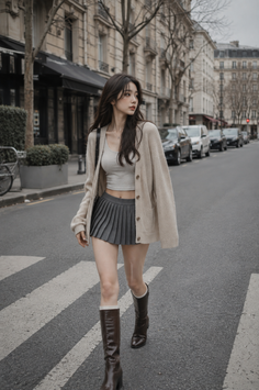 Woman in a pleated skirt and crop top walking on a city street