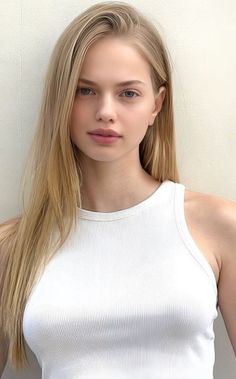 Young woman with long blonde hair wearing a white tank top