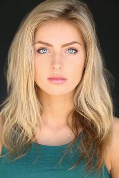 Woman with blonde hair and blue eyes wearing a teal top