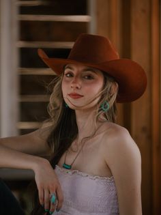 Woman in a cowboy hat and strapless top with turquoise jewelry