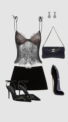 A flat lay of a black lace camisole, skirt, heels, and accessories