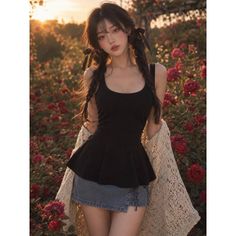Woman with braided hair in a black top and denim skirt in a rose garden at golden hour