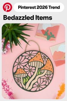 Diamond painting of mushrooms and flowers on a pink background with craft supplies