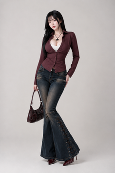 Woman with long black hair wearing a maroon shirt and flared jeans