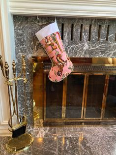 Christmas stocking with a cowboy print hanging on a marble fireplace