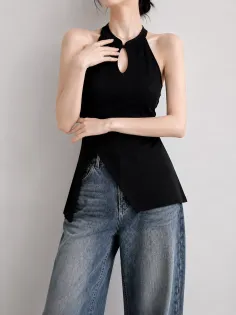 Woman in a black halter top with a keyhole neckline and wide leg jeans