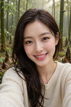 Smiling woman with long wet hair in a bamboo forest wearing a sweater