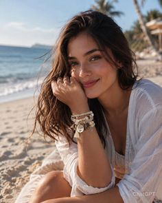 Woman with long hair wearing a white shirt and bracelets on a beach