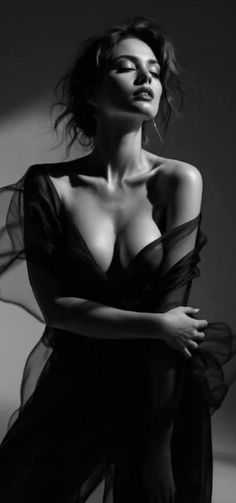 Woman in sheer fabric with dramatic lighting in black and white