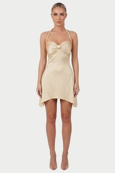 Woman in a champagne mini dress with a braided halter neckline