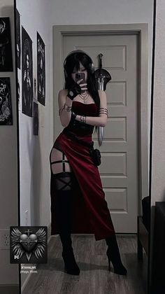 Woman in a red dress with garter straps and headphones taking a mirror selfie