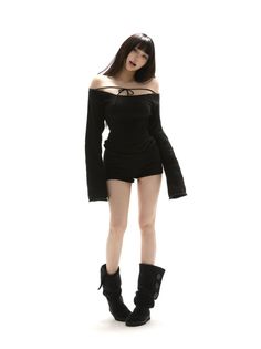 Woman in a black off-shoulder top and shorts with black boots