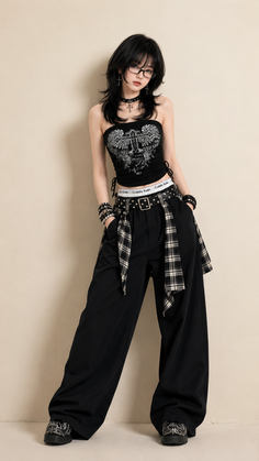 Woman with black hair and glasses wearing a gothic-style outfit