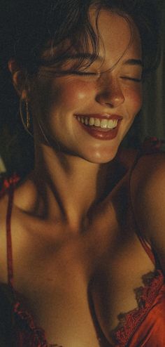 Woman in red lingerie with closed eyes and a happy smile