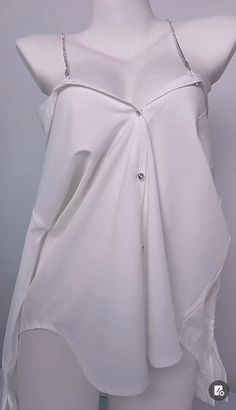 White off-shoulder shirt with rhinestone straps on a mannequin