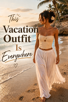 Woman in a strapless top and white pants walking on a beach at golden hour