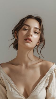 Woman with brown hair wearing an off-shoulder top with soft lighting
