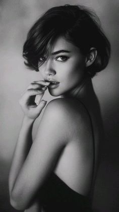 Woman with short hair in a provocative pose, shot in black and white
