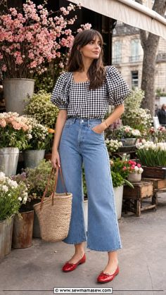 Woman in a gingham top and wide leg jeans at a flower market