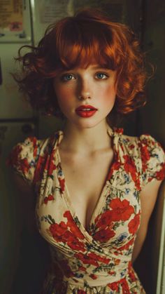 Woman with red hair and blue eyes wearing a floral dress with cleavage