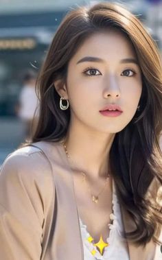 Woman with long brown hair wearing earrings and a necklace