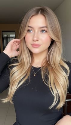 Woman with blonde hair and a black top looking to the side