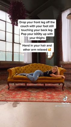 Woman in jeans and a black shirt posing on a yellow couch