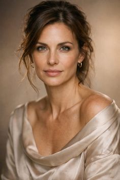 Woman with brown hair and green eyes wearing a draped top