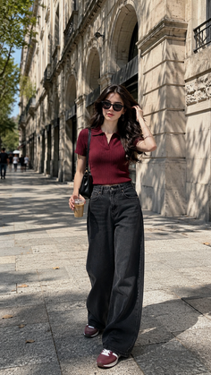 Woman in sunglasses and wide leg jeans walking on a city street