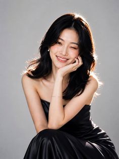 Woman in a black strapless dress winking with backlight
