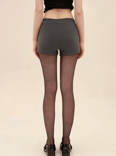 Person in polka dot tights and short shorts from behind