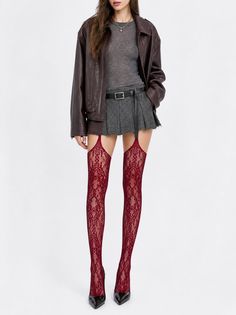 Woman in a leather jacket, mini skirt, and red lace stockings