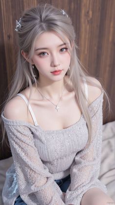 Woman with silver hair wearing an off-shoulder sequined top and cross necklace