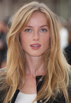 Woman with blonde hair and blue eyes looking directly at the camera