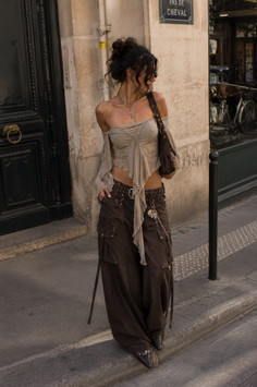 Woman in an off-shoulder top and cargo pants on a street