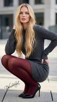 Woman with long blonde hair in a gray dress and red tights squatting outdoors
