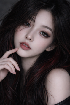 Woman with long dark hair and red highlights, soft lighting