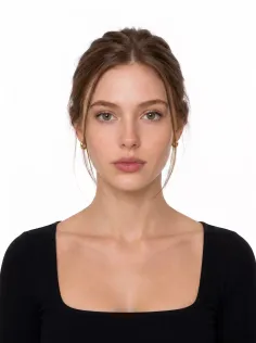 Woman with brown hair in an updo wearing a black square-neck top