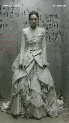 Woman in a white hanbok-style dress standing against a graffiti-covered wall