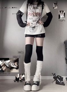 Person in a dark aesthetic outfit with a graphic t-shirt and platform shoes
