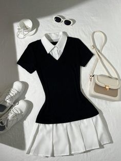 Black and white dress with accessories laid flat on a white surface