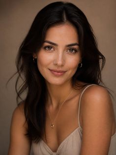 Woman with long dark hair wearing a spaghetti strap top and gold jewelry