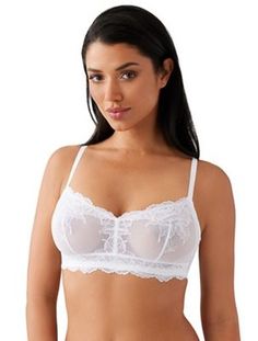 Woman in white lace lingerie with dark hair and exposed skin