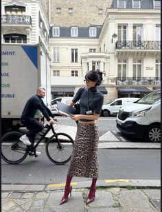 Woman in a leopard print skirt and cropped top on a city street