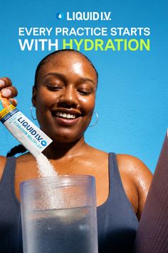 Woman smiling while pouring a hydration drink into a glass of water