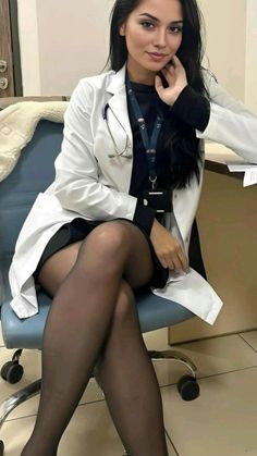 Woman in a doctor's coat and black tights sitting indoors