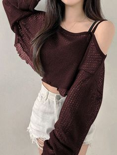Woman in a maroon crop top and white distressed shorts